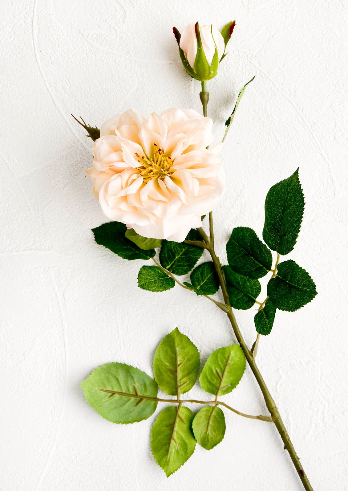 Realistic looking faux rose flower, complete with leaves, stem, flower and bud