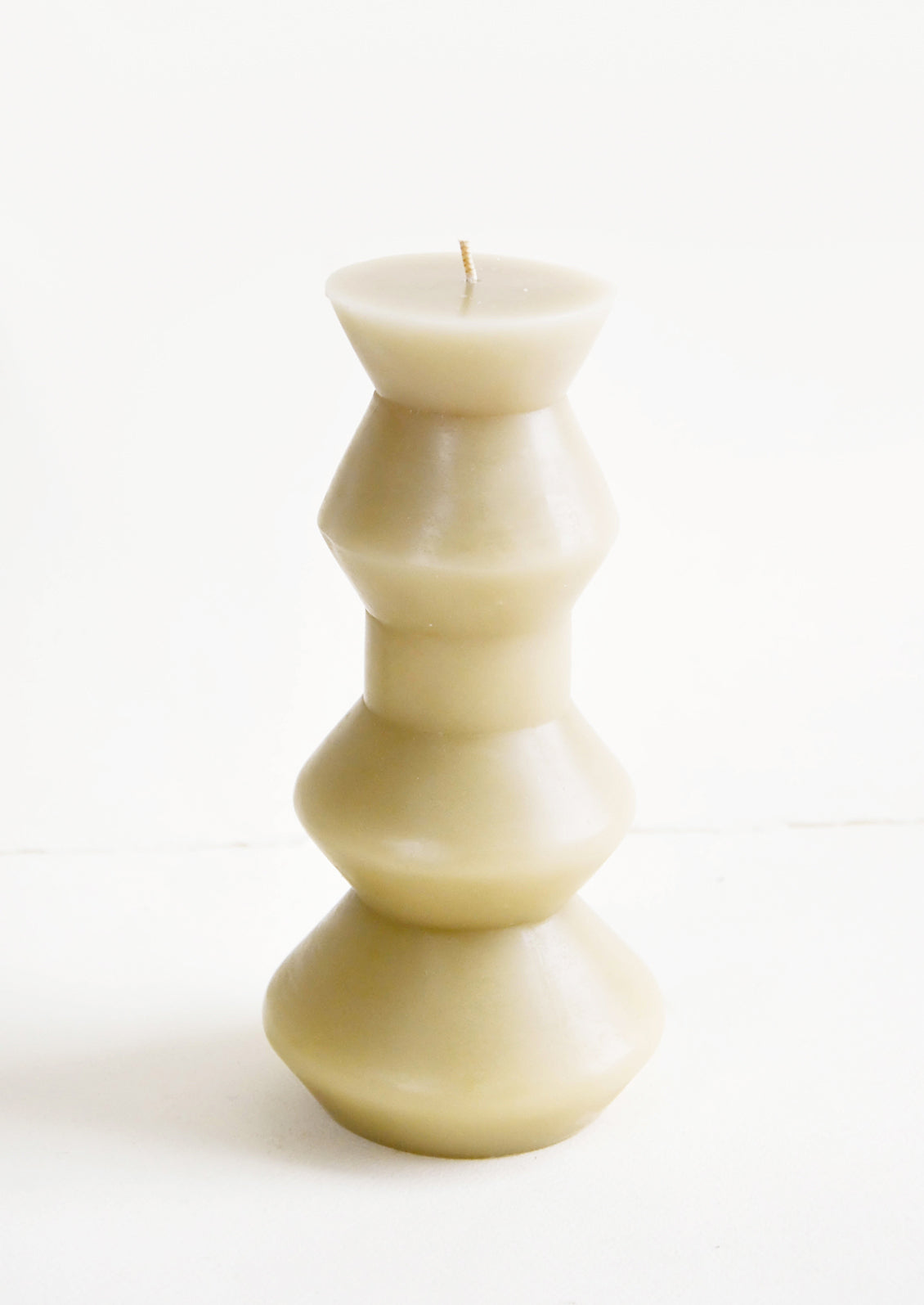 Shapely, sage colored pillar candle in chunky geometric form