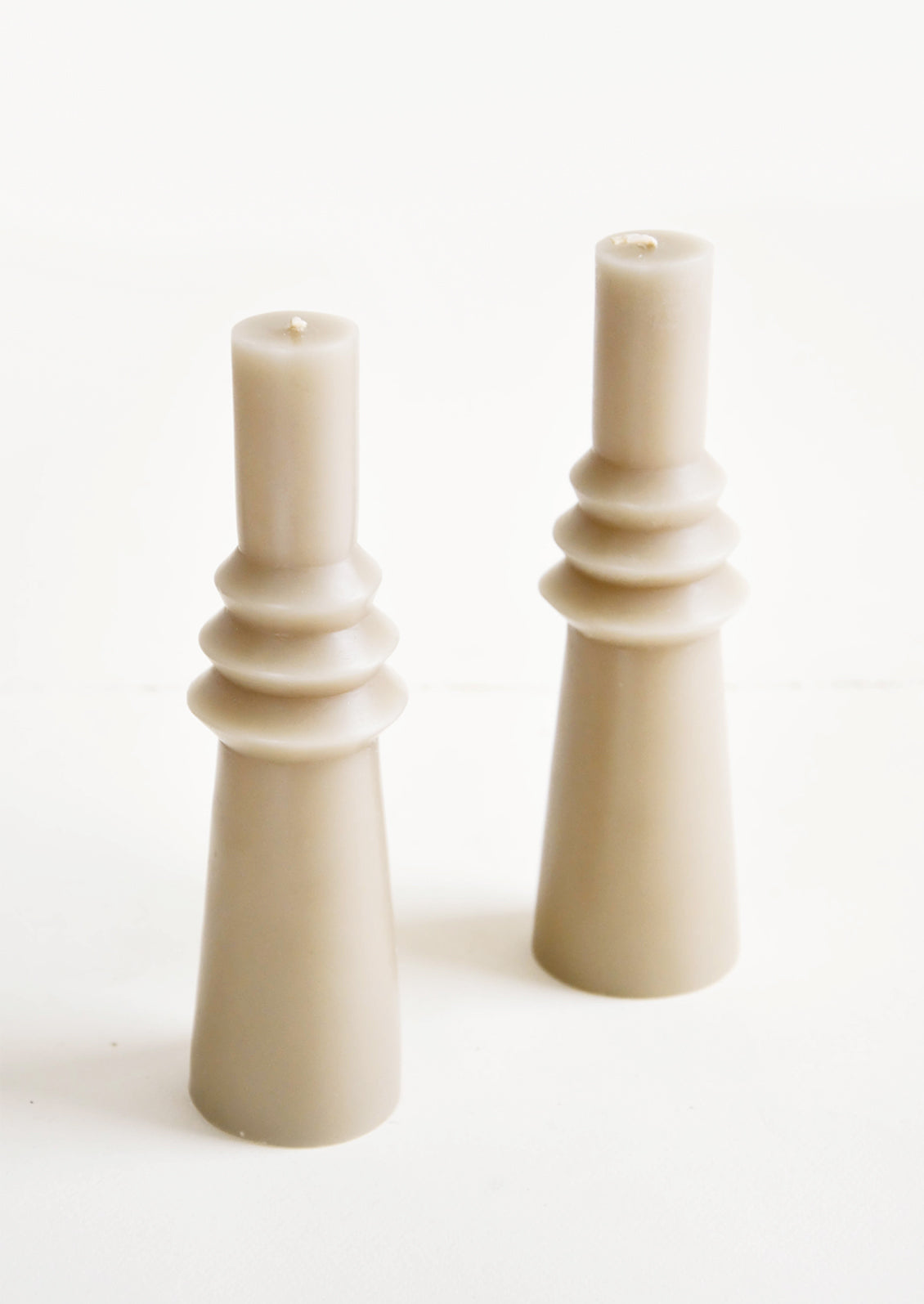Shapely, sage colored pillar candle in skinny geometric form