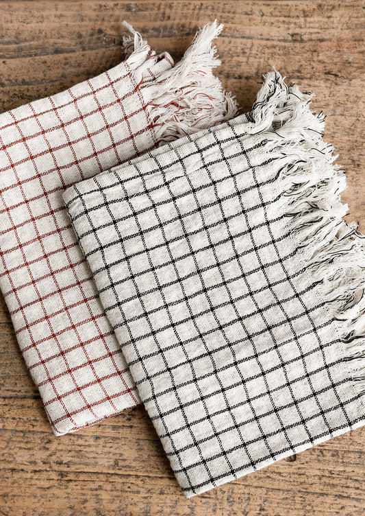 Gauzy gingham tea towels in black and red colorways.