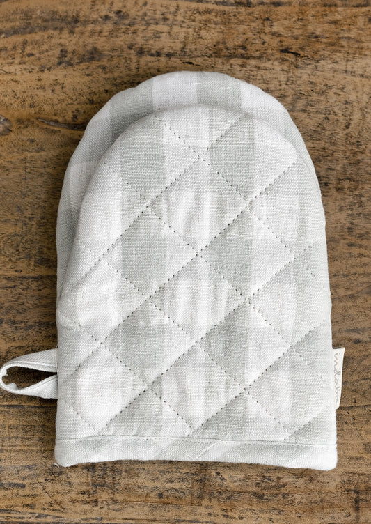 A gingham oven mitt in pale blue colorway.