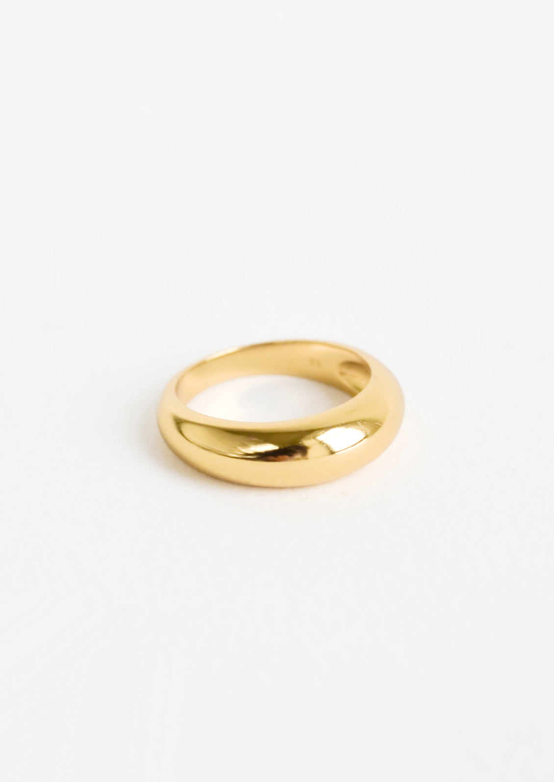 Golden ring with bulbous, dome-like front