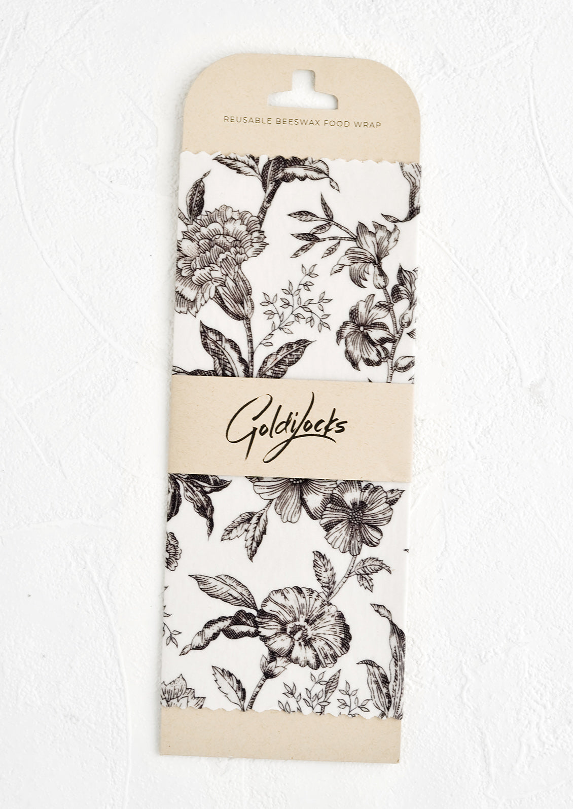 Packaged black and white floral print reusable beeswax wrap.