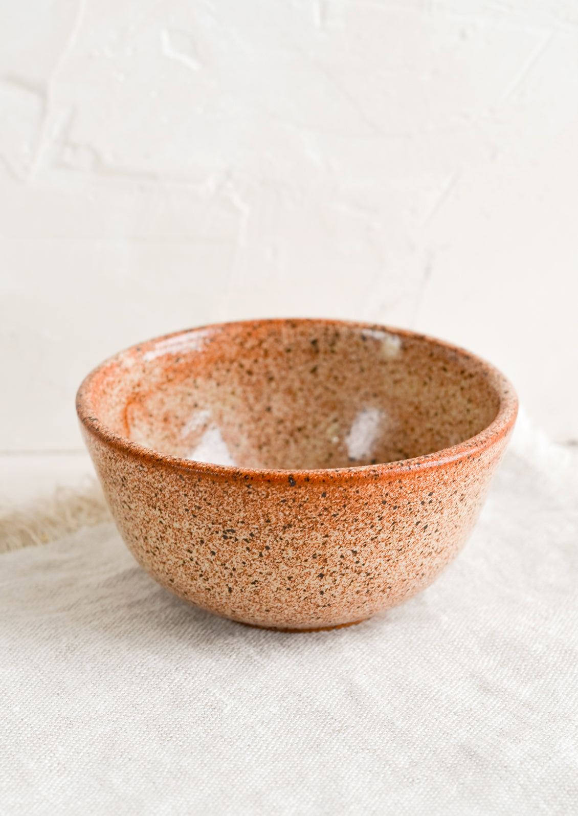 A small ceramic bowl in speckled rust.