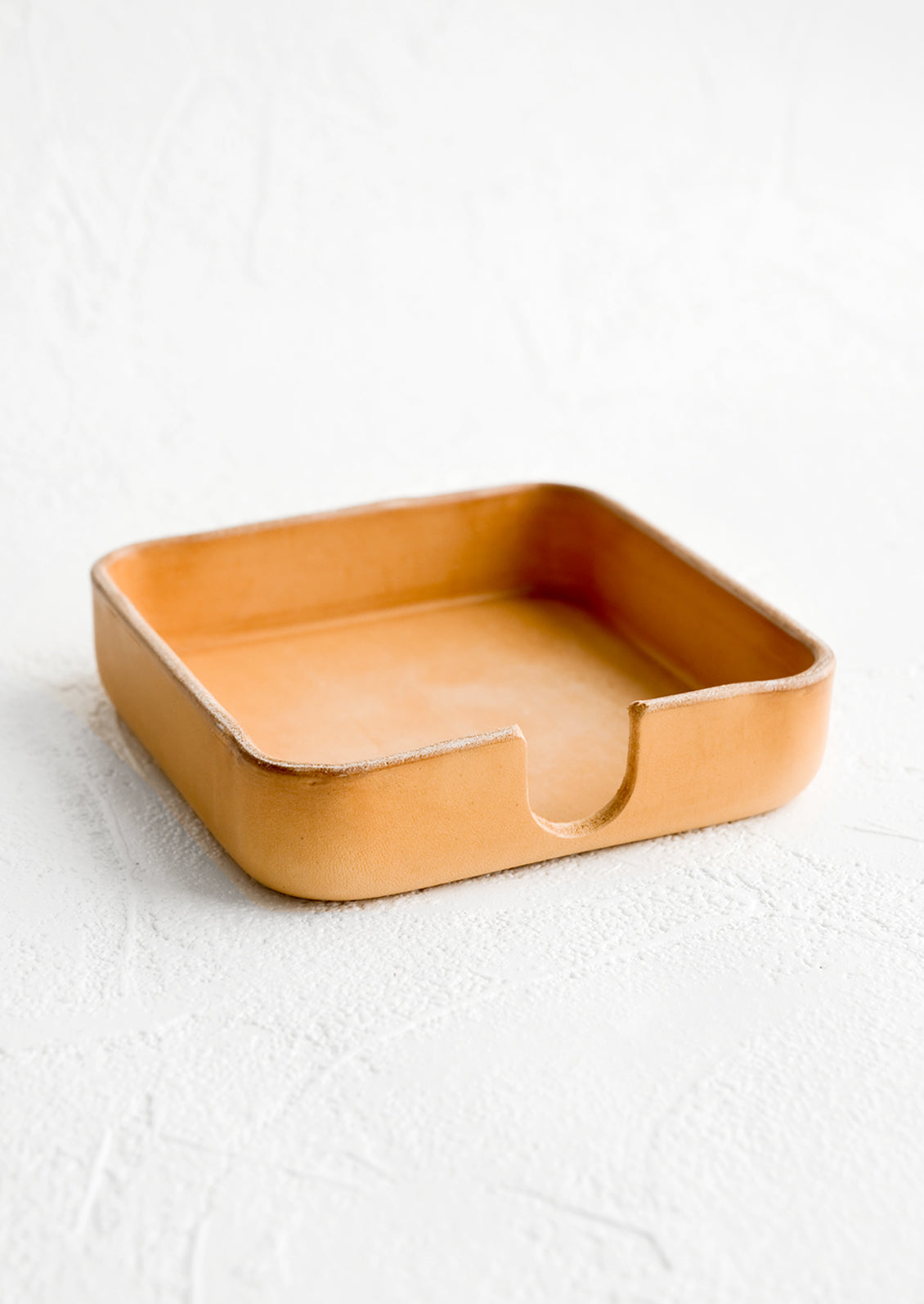 Structured natural leather coaster holder.