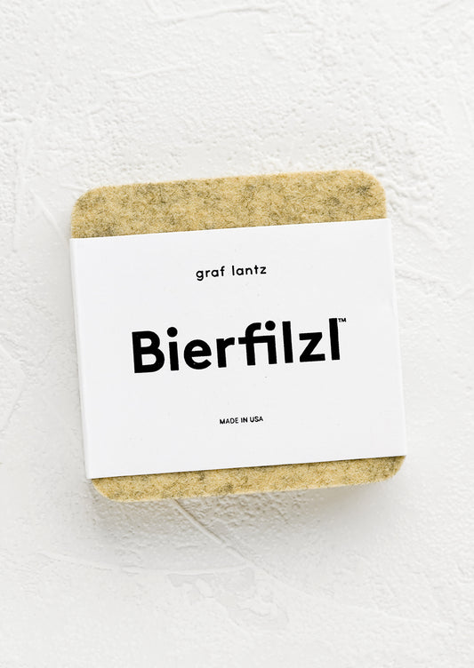 A package of square wool felt coasters in millet tan.