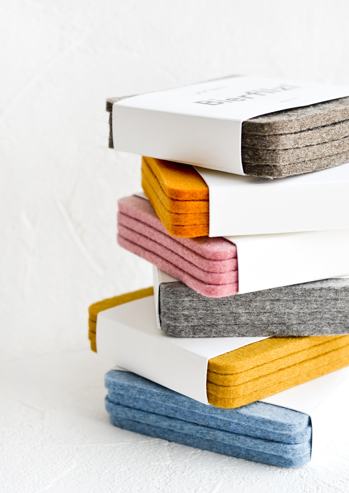 A stack of colorful felt coaster sets.