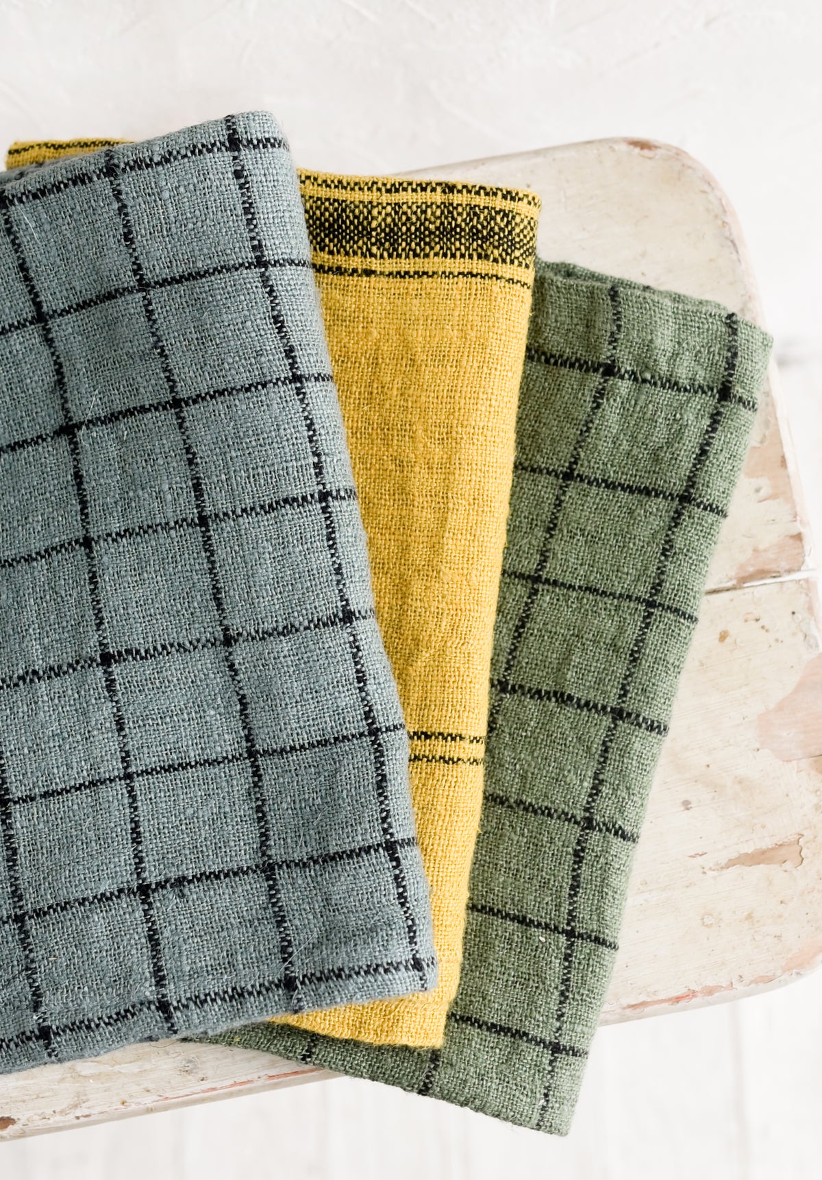 Folded woven tea towels.