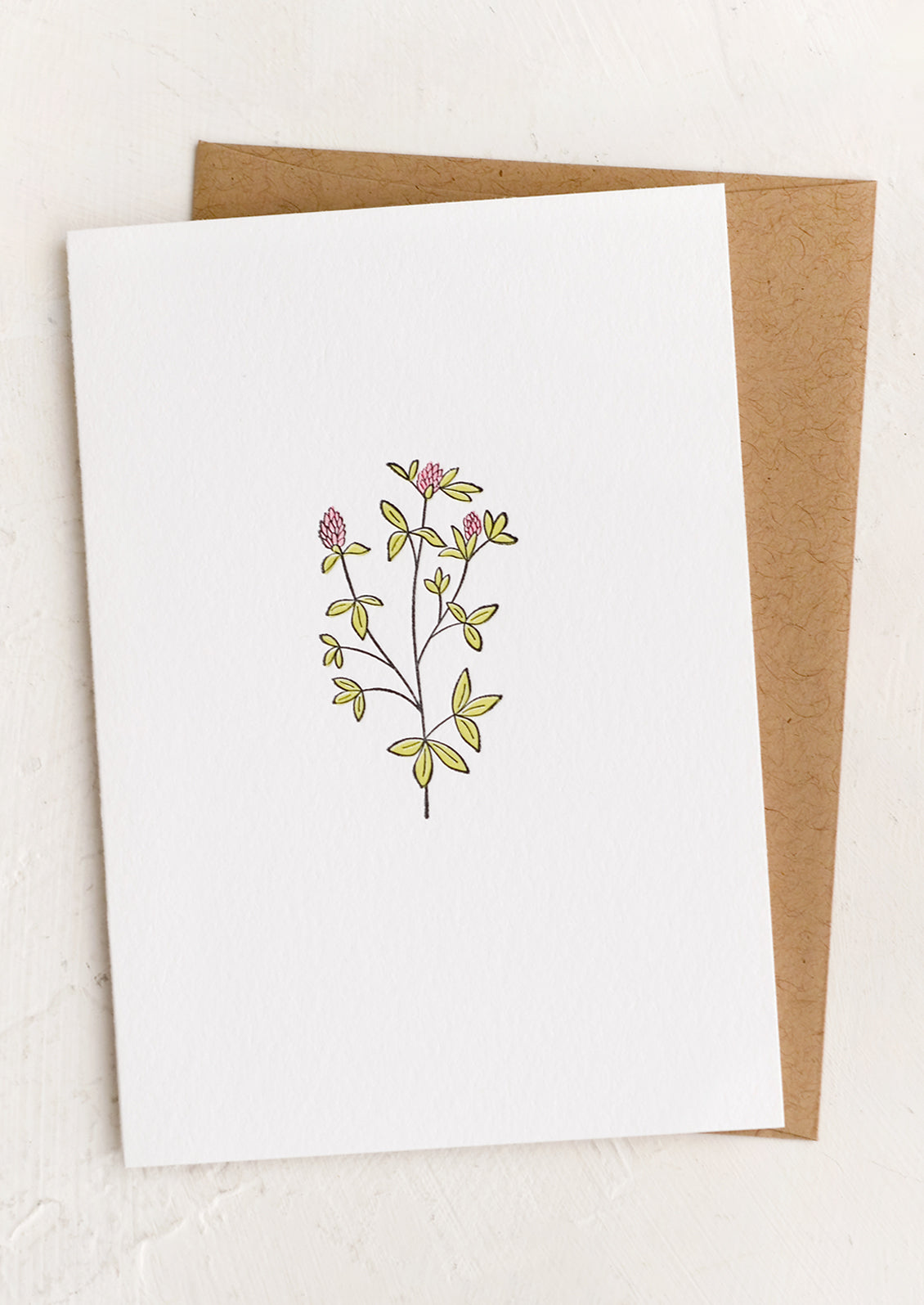 A blank white card with red clover illustration.