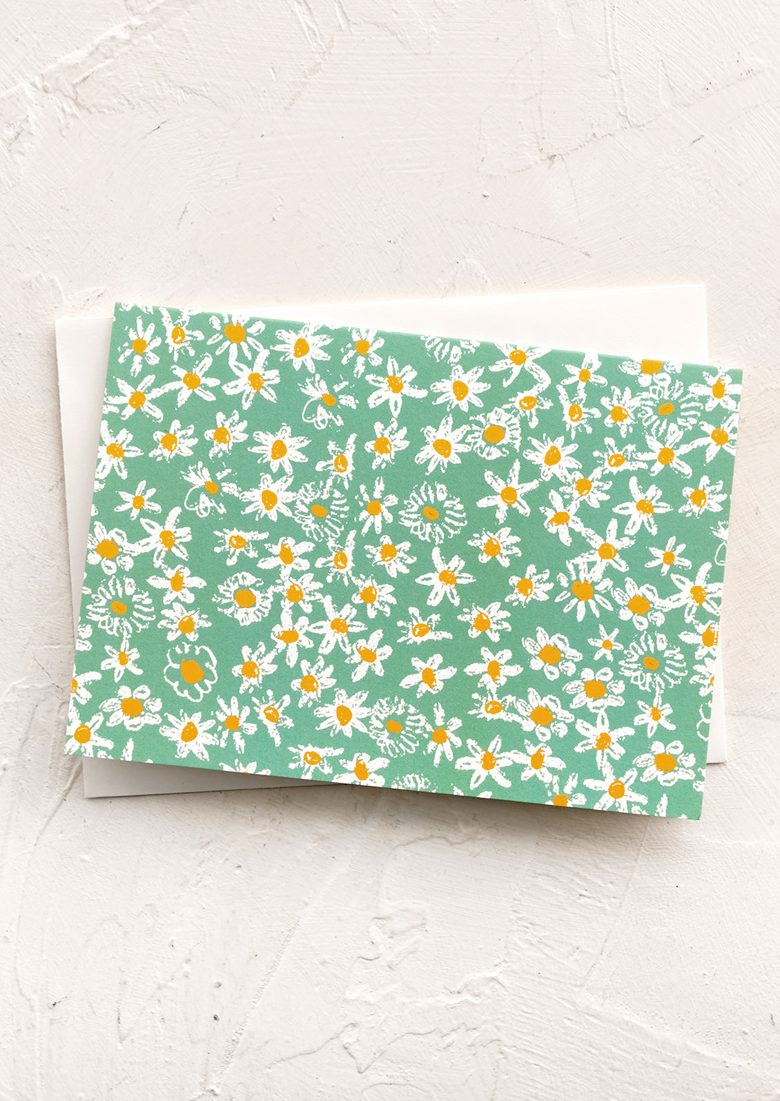 A green daisy print notecard.