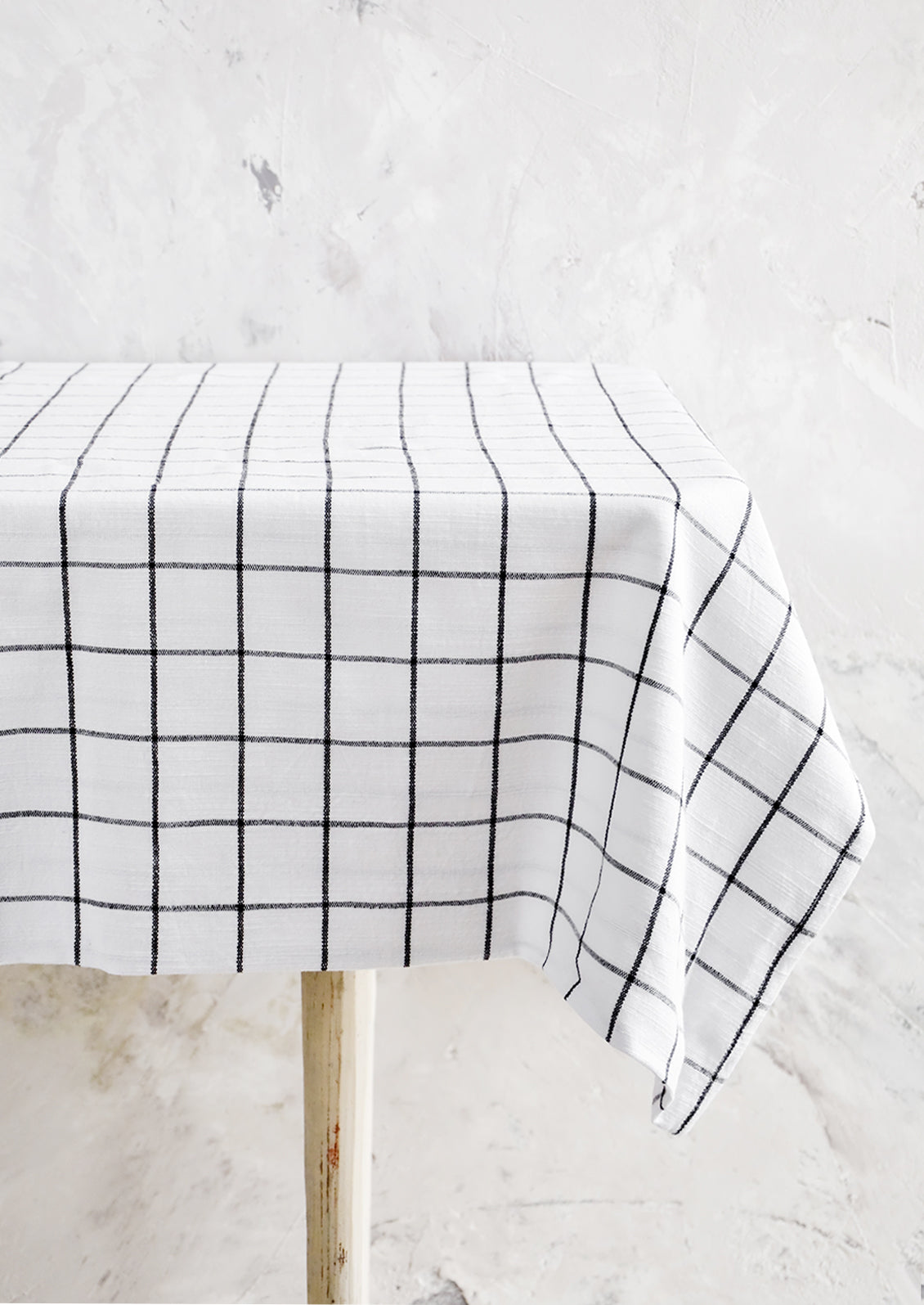 Black and white grid patterned tablecloth displayed over table