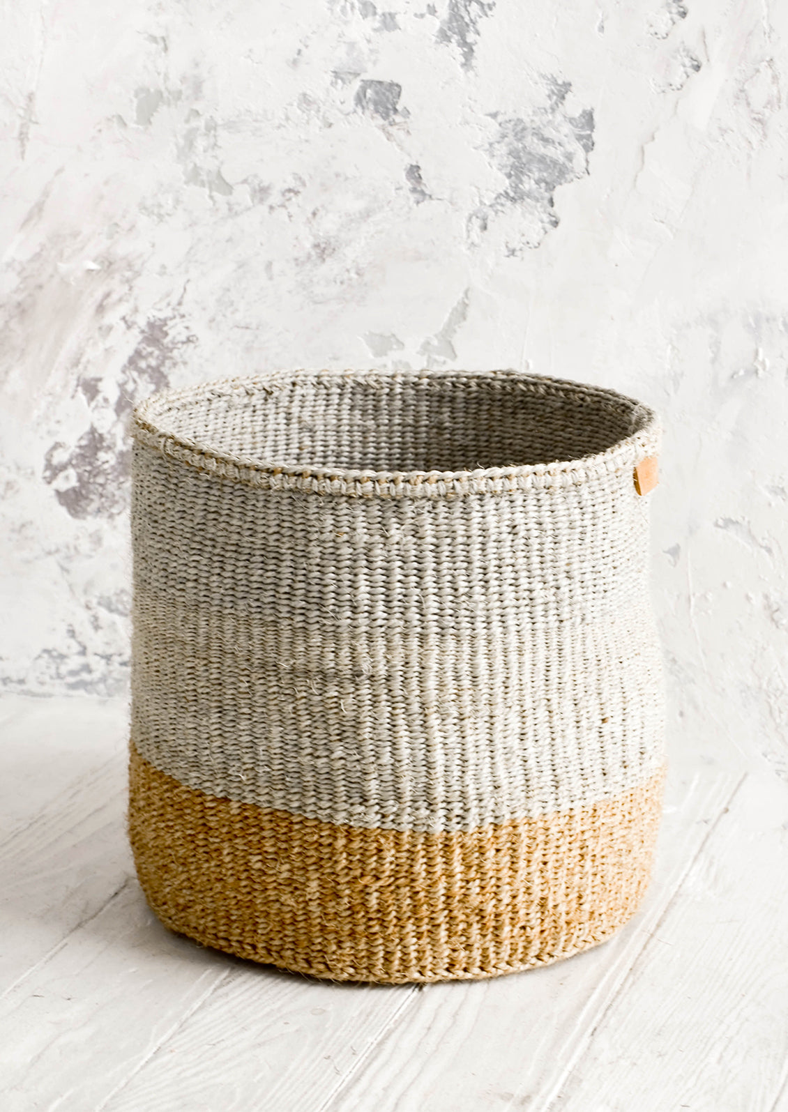 Sisal woven storage basket in grey & natural colorblock. 
