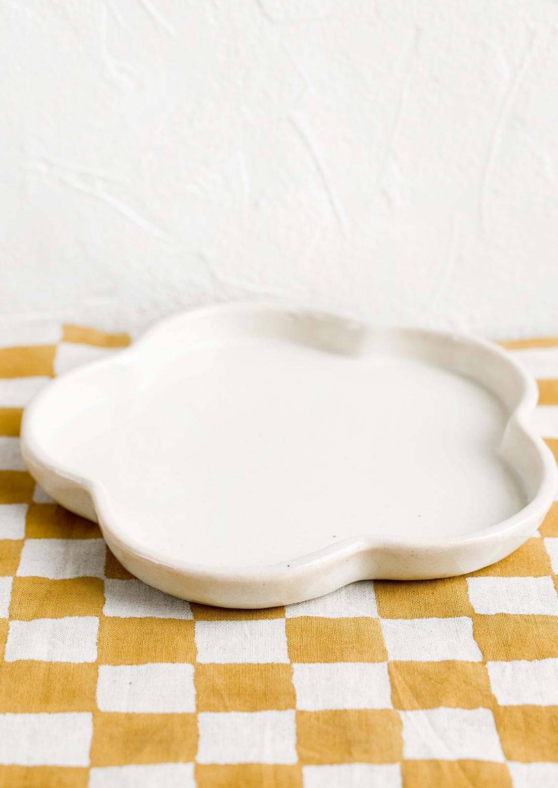A white flower shaped ceramic plate.
