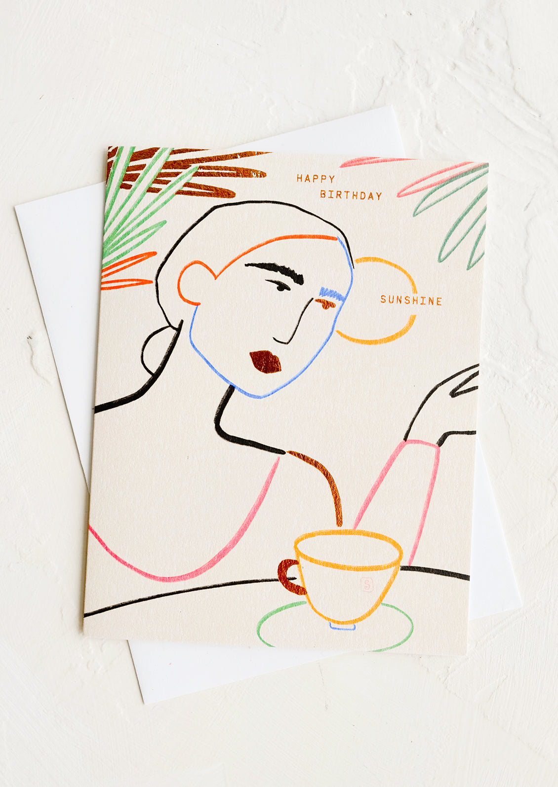 A greeting card with silhouette of woman drinking coffee, text reads "Happy birthday sunshine".