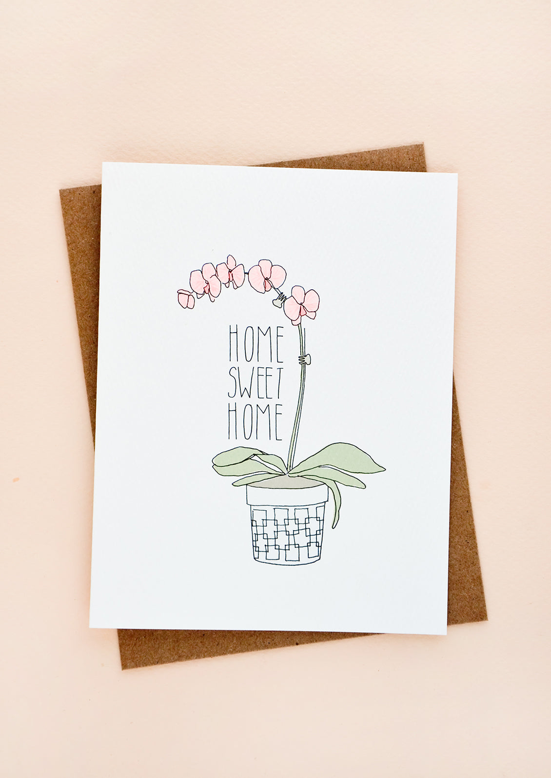 Greeting card with image of potted orchid and text reading "Home Sweet Home"
