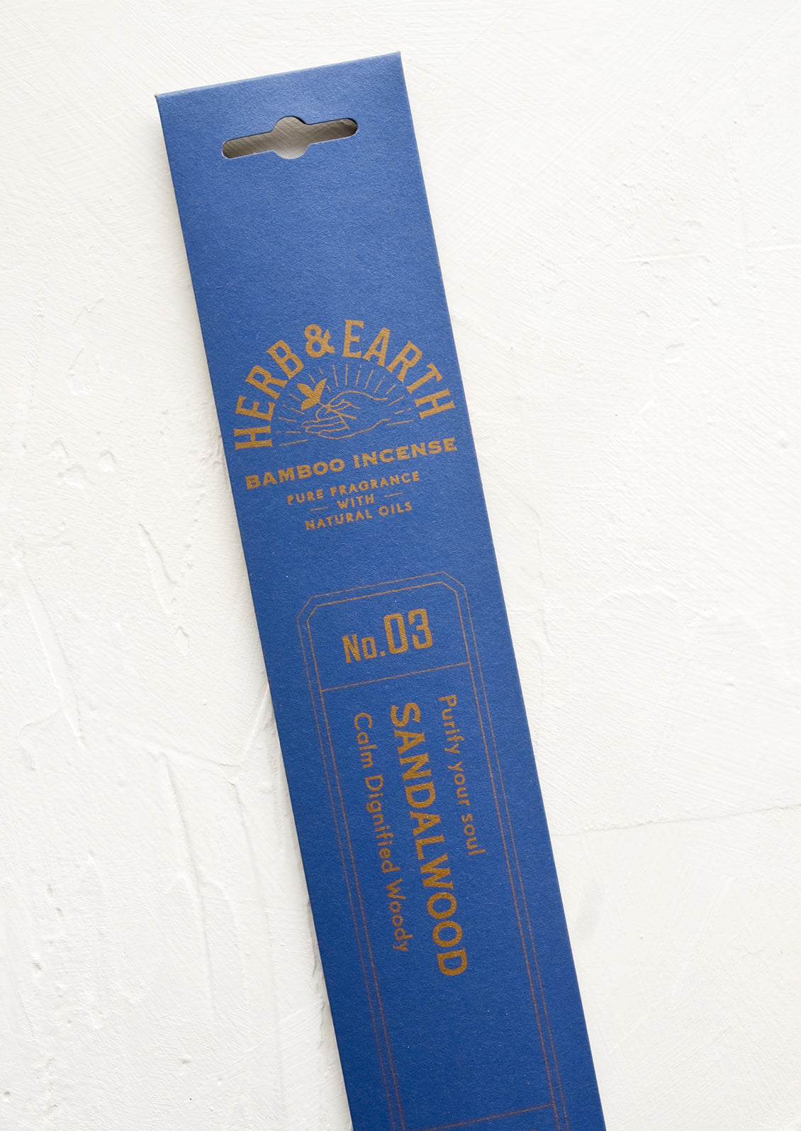 A blue packaging sleeve containing sandalwood scented incense.