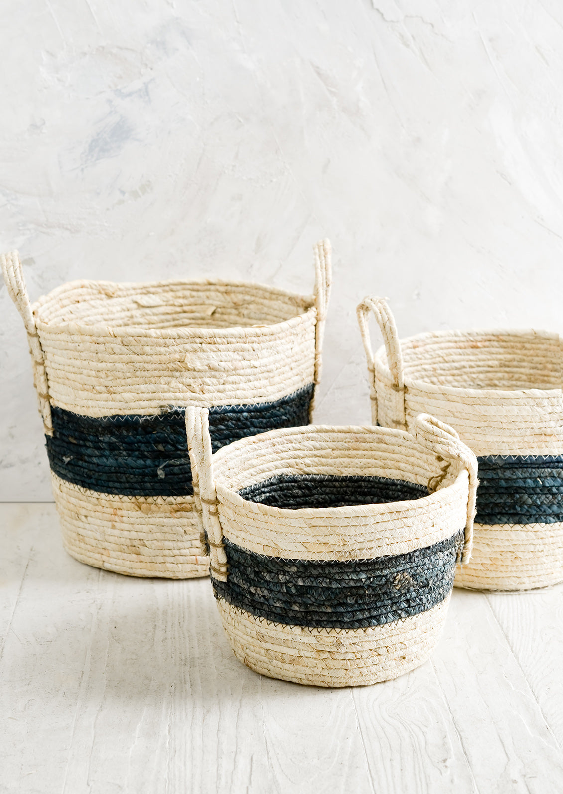 Three natural fiber storage baskets in three incremental sizes.
