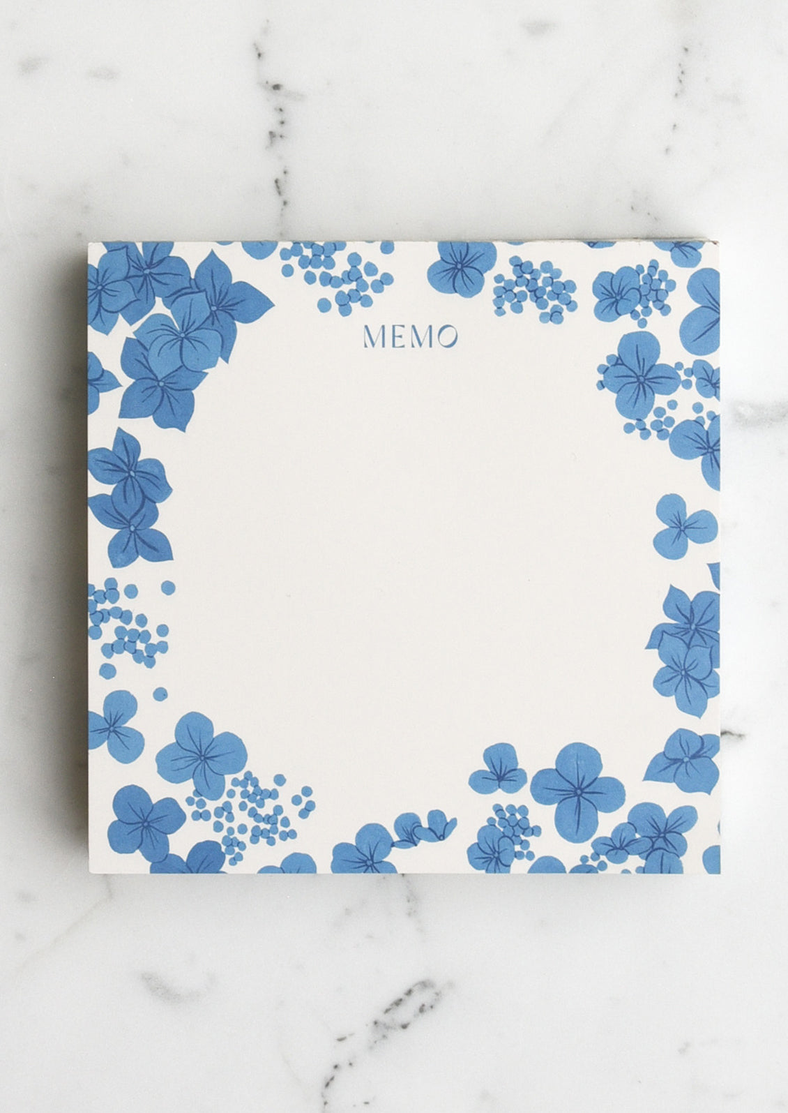 A square notepad with blue hydrangea border, reading "memo" at the top
