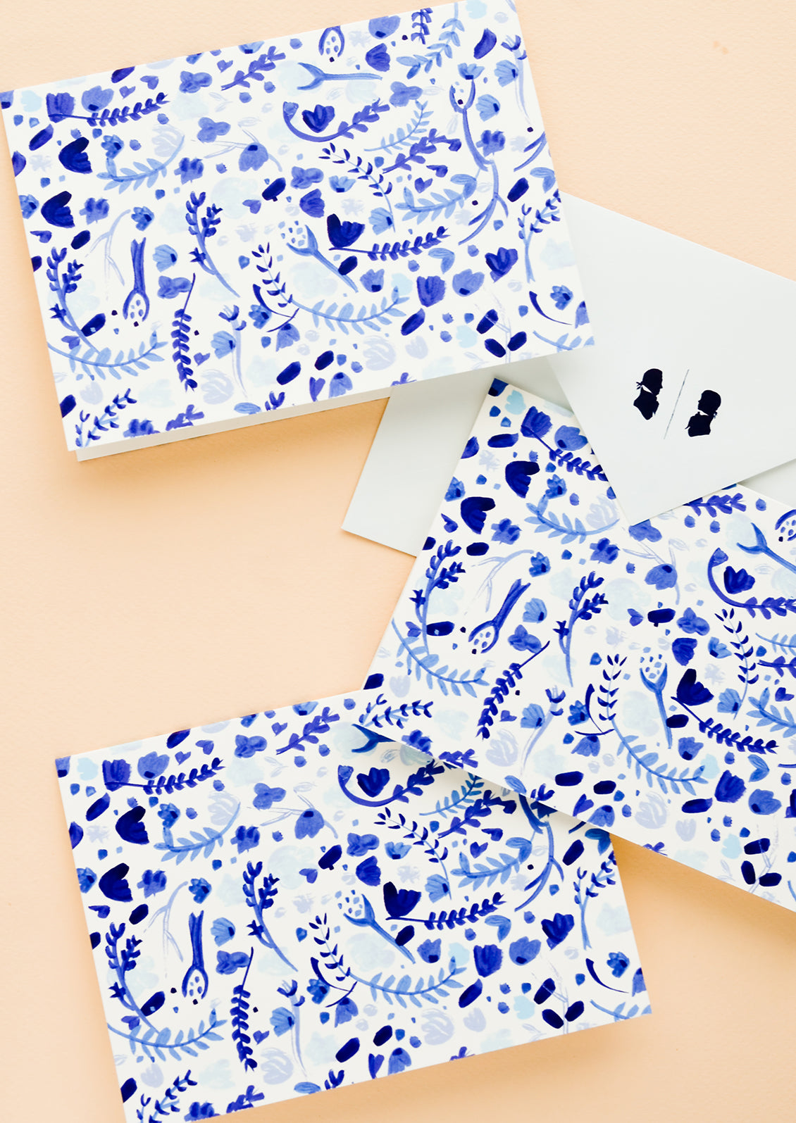 A set of identical greeting cards with white and blue watercolor floral print.