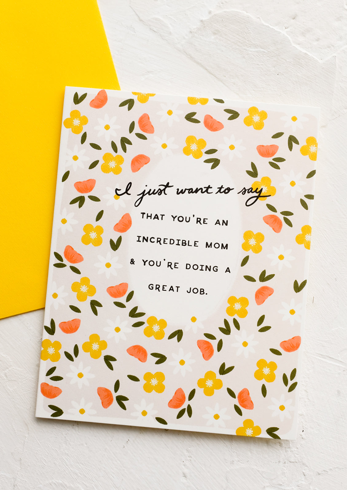 A floral printed card reading "I just want to say that you're an incredible mom and you're doing a great job".