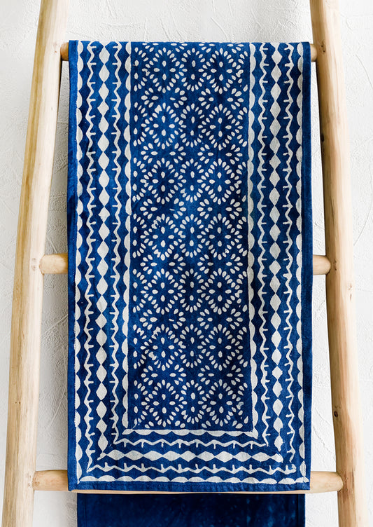An indigo cotton table runner with block printed design.
