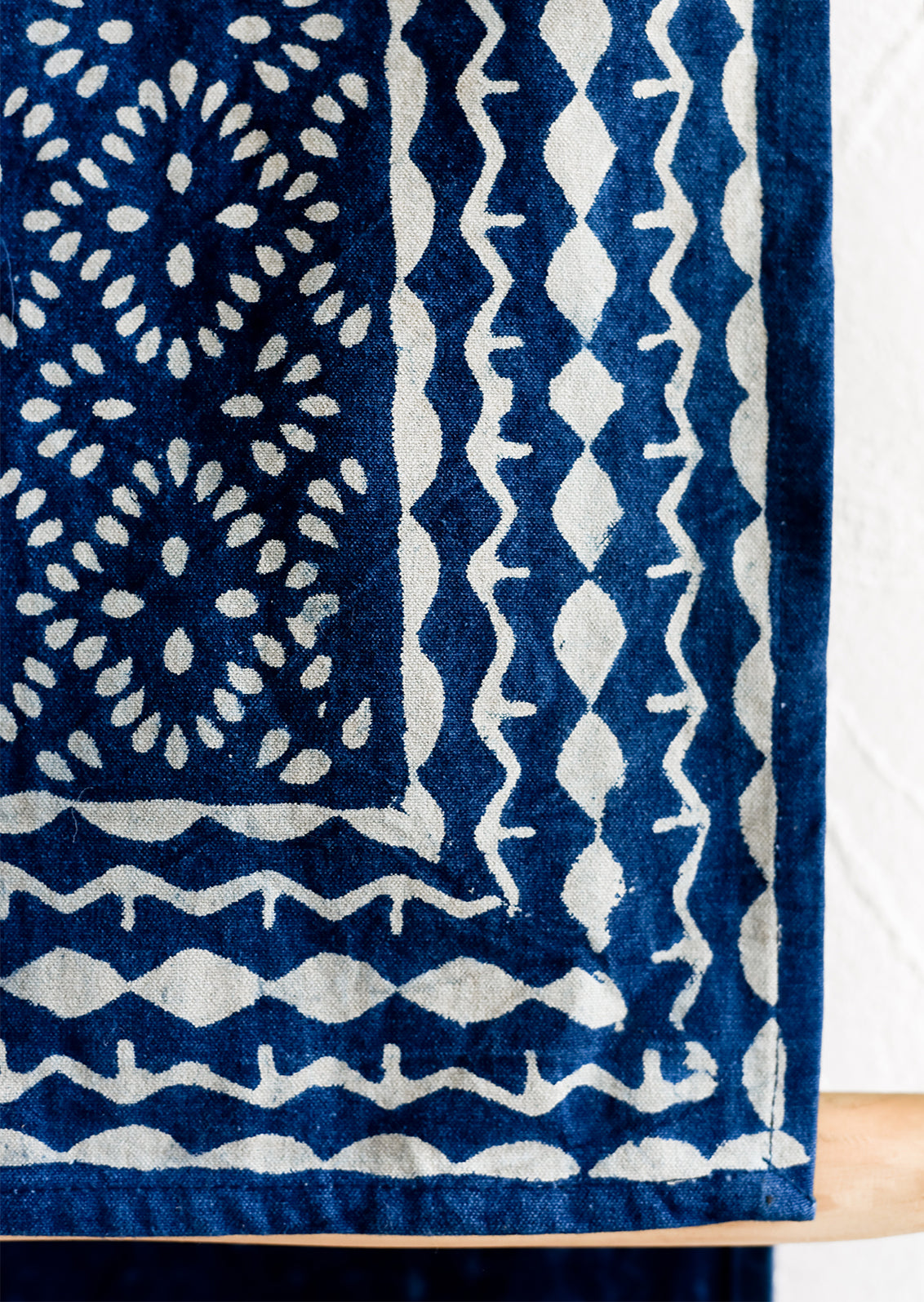 An indigo cotton table runner with block printed design.