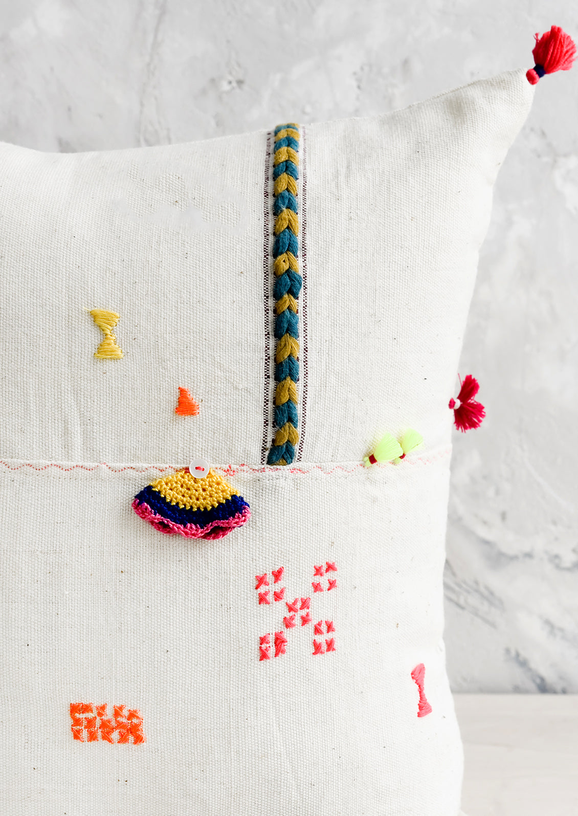 Applique and embroidery detailing on throw pillow.