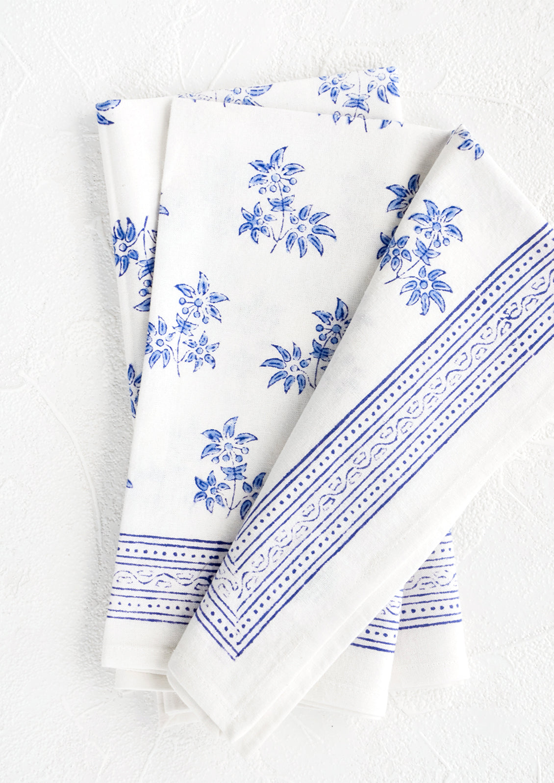Pair of block printed cotton dinner napkins with blue floral pattern