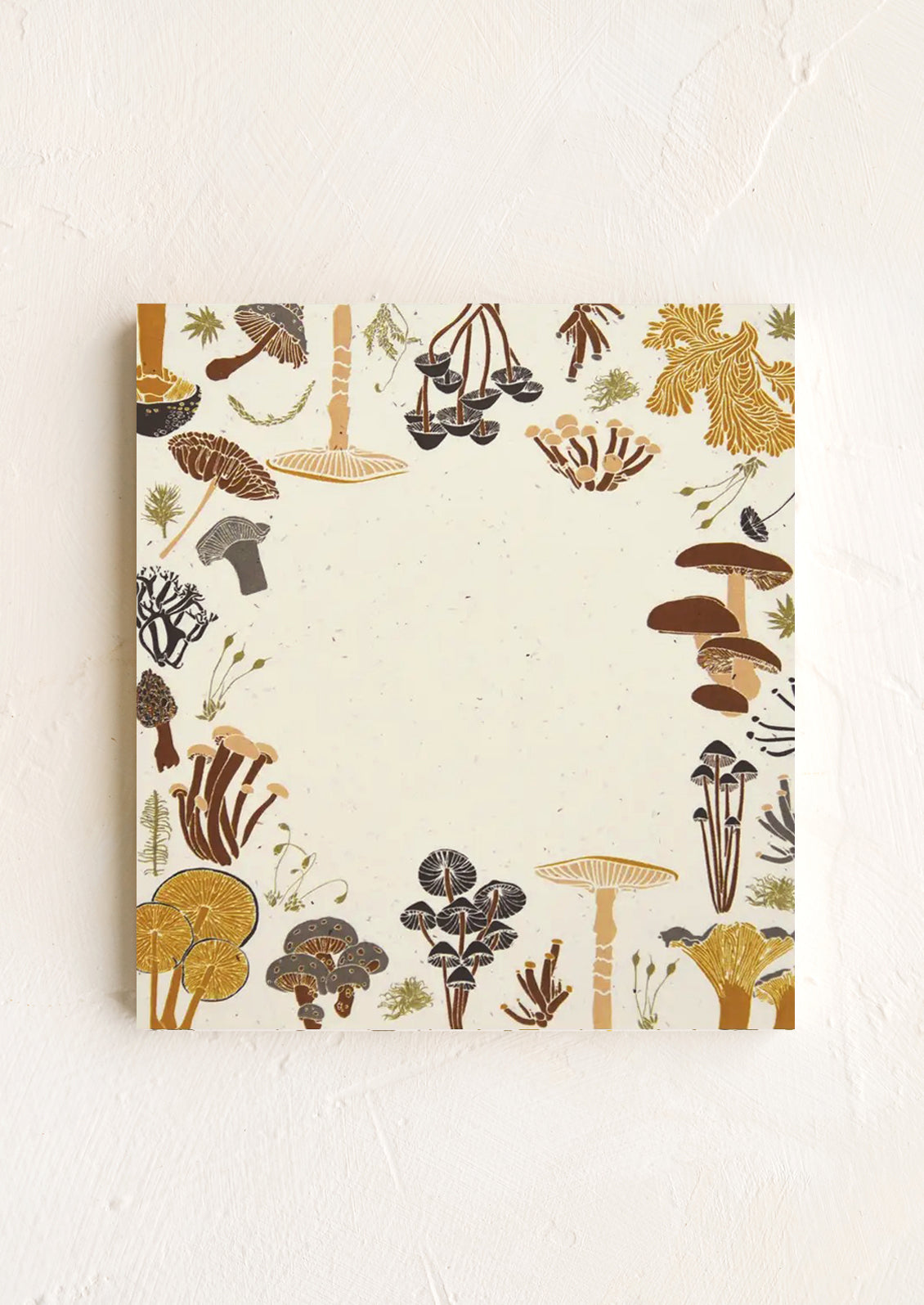A small square notepad with mushroom border.