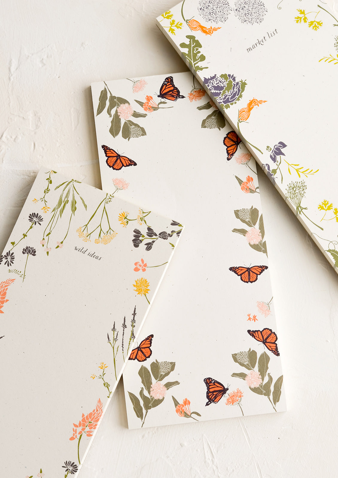 Various list making notepads with botanical print borders.