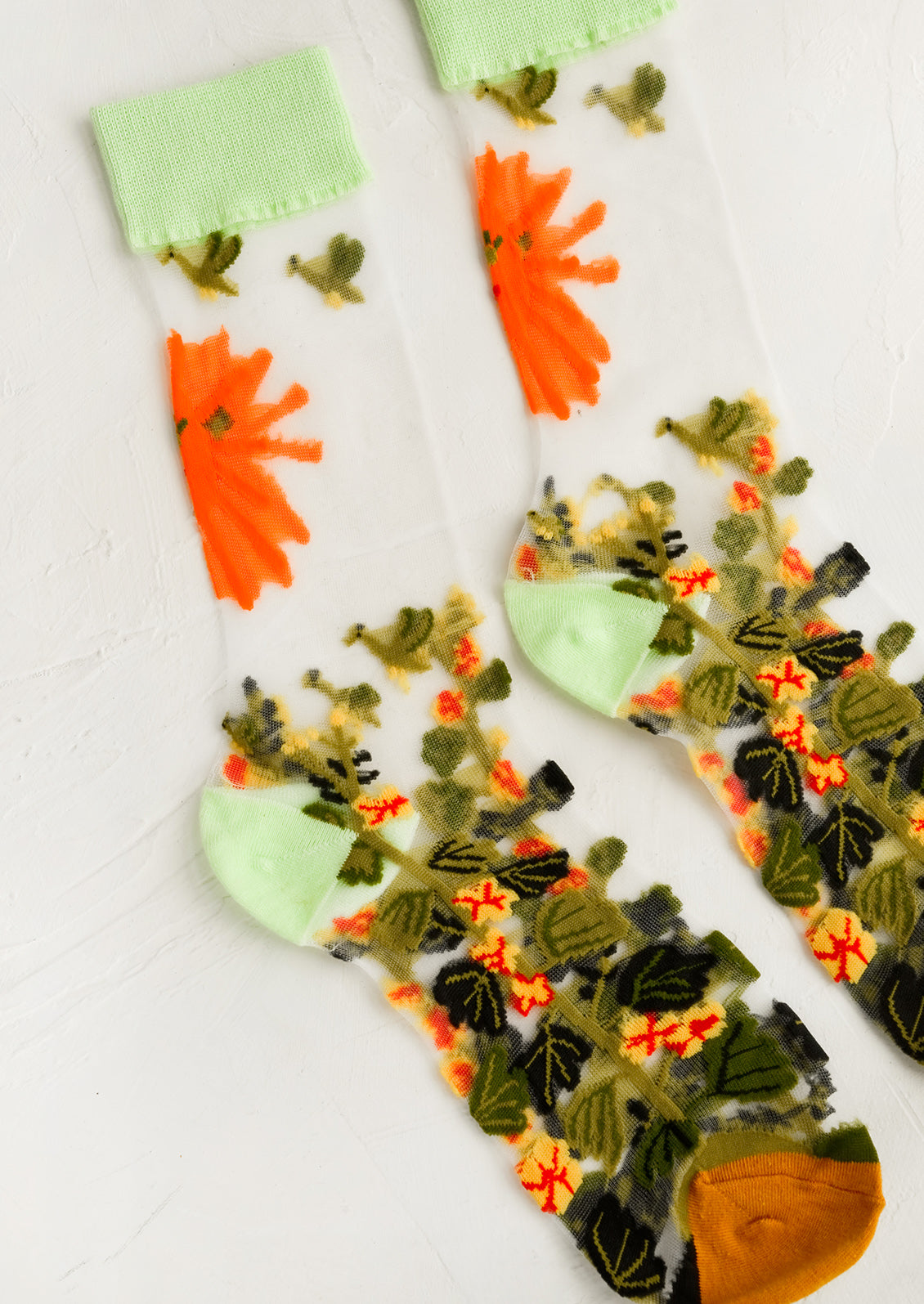 Sheer mesh socks with jungle print and mint green trim.