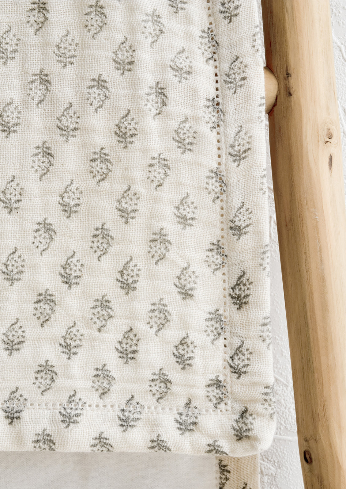 A table runner with hemstitch detailing.