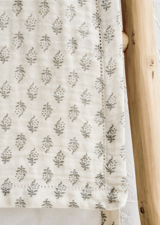 A table runner with hemstitch detailing.