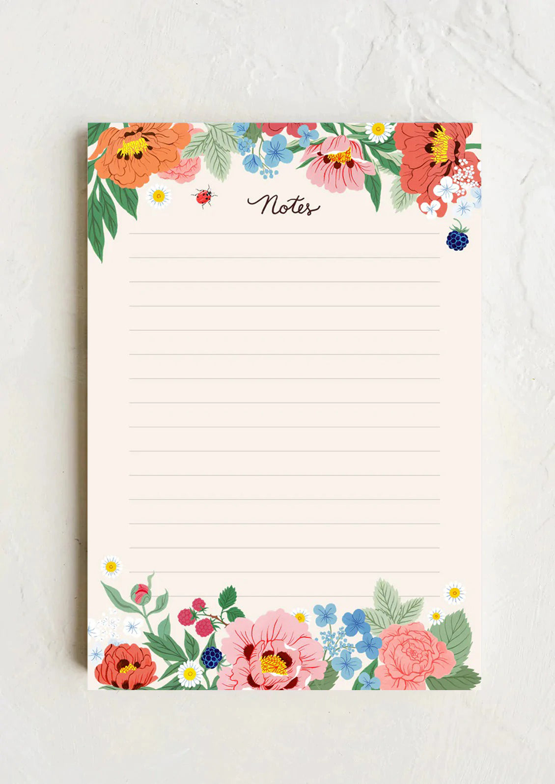 An off-white ruled notepad with floral garden border reading "Notes" at top.