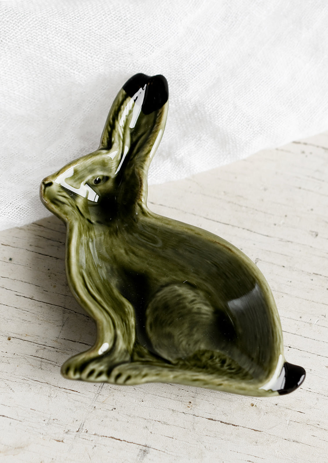 A rabbit shaped ceramic trinket dish in forest green.