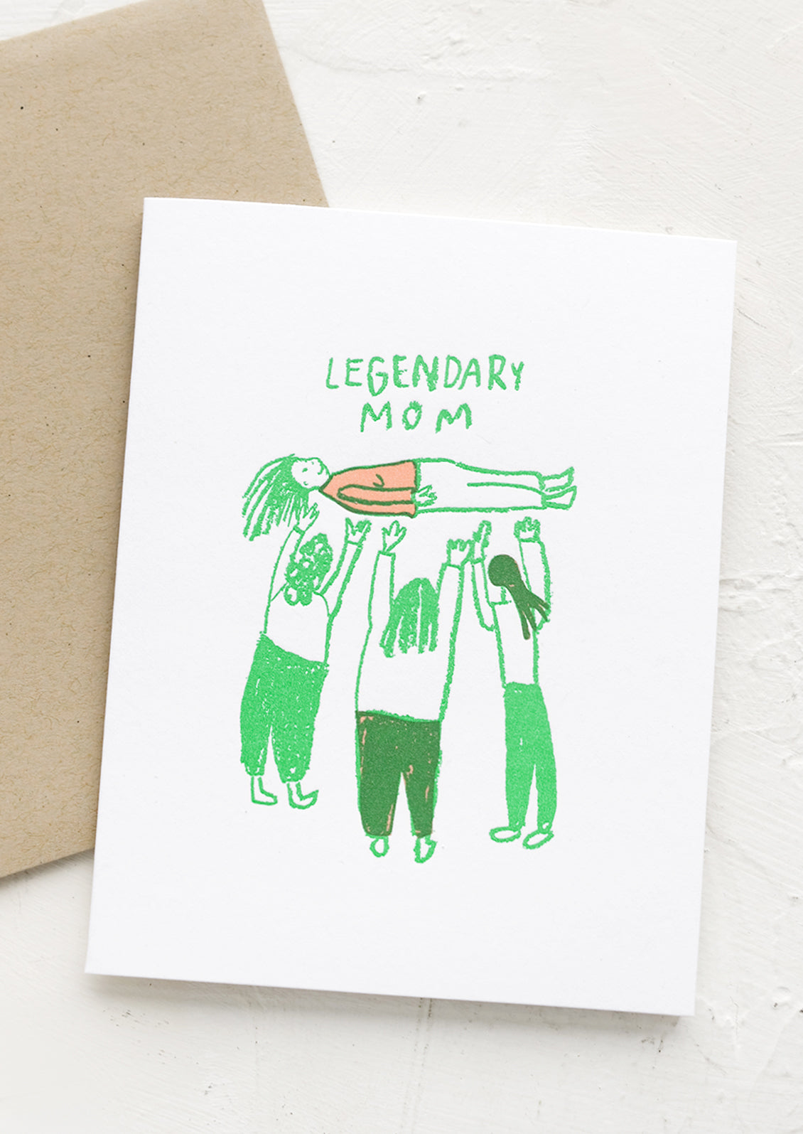 A greeting card with image of three people holding up a woman, text reads "Legendary Mom".