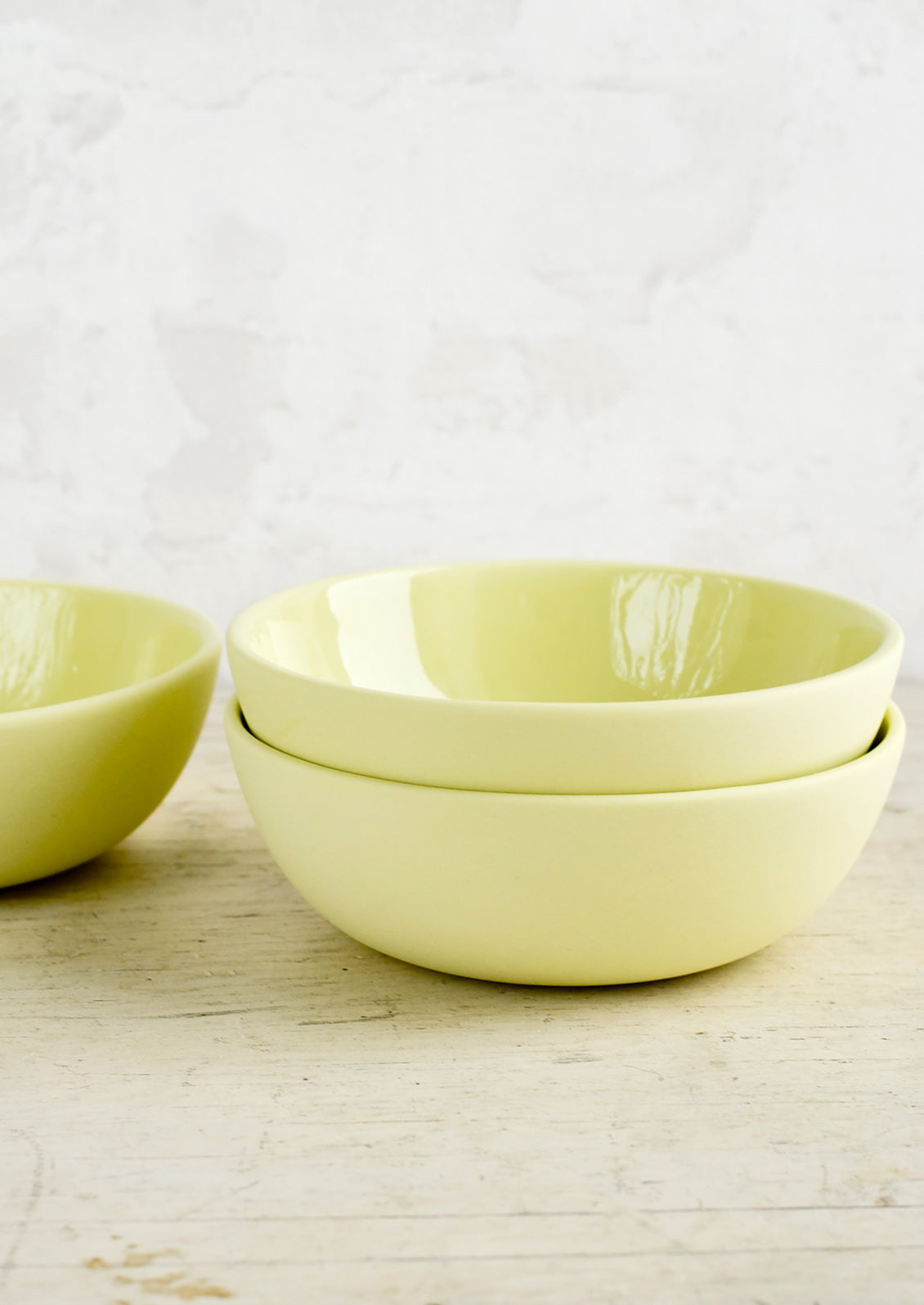 Matte porcelain bowls in citron yellow hue with glossy interior.