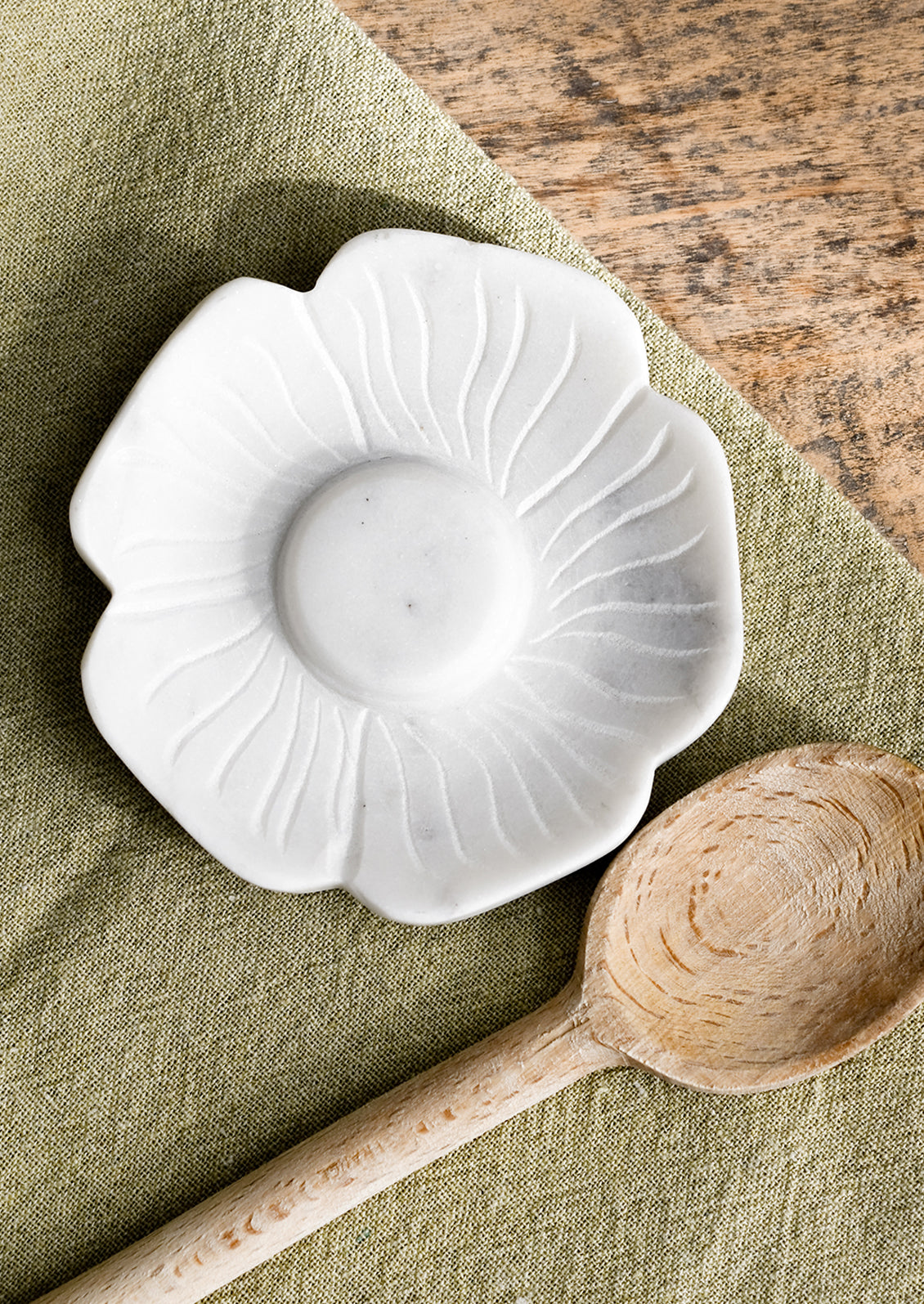 A white marble spoon rest in flower shape.