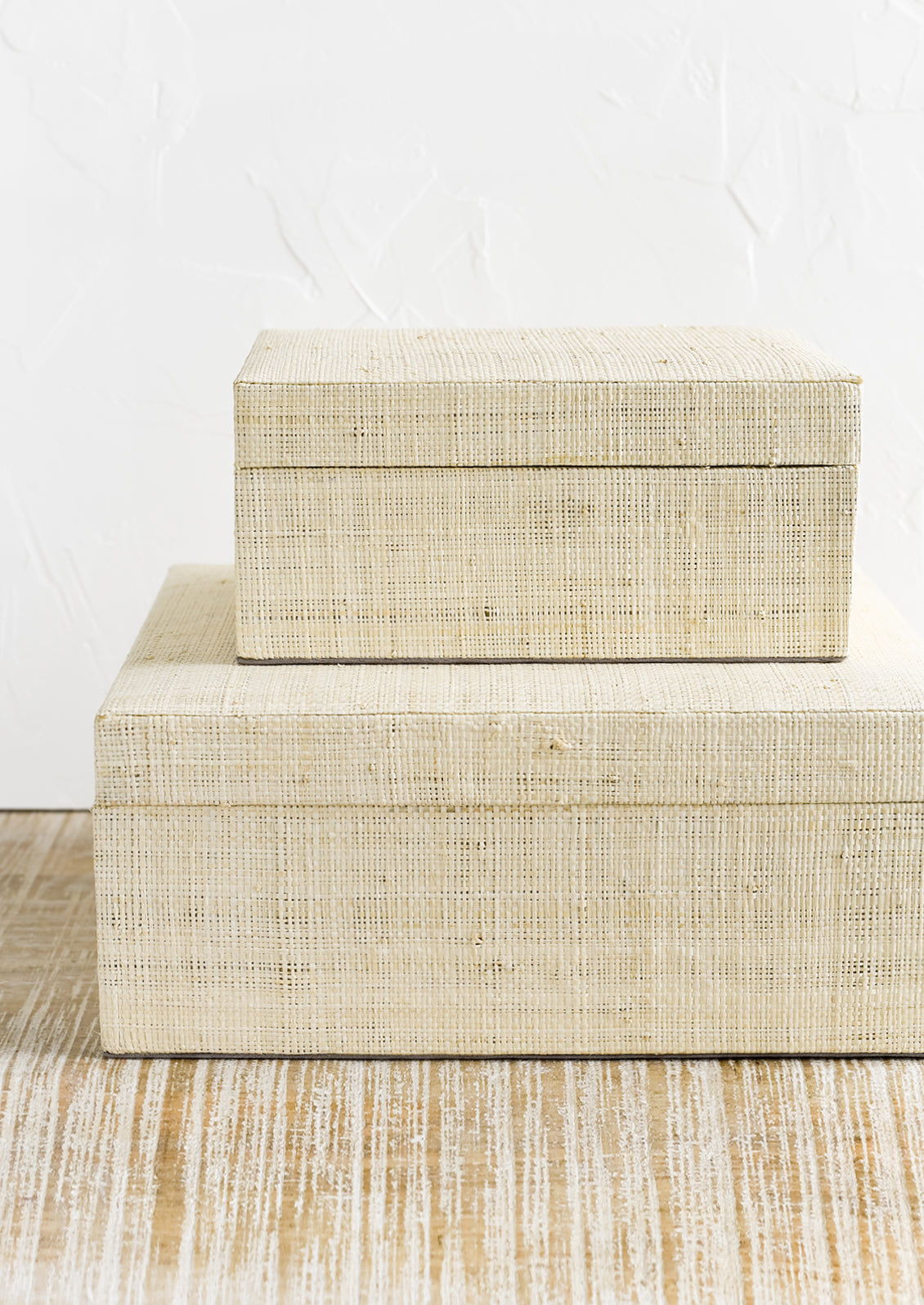 Small and large upholstered linen storage boxes.
