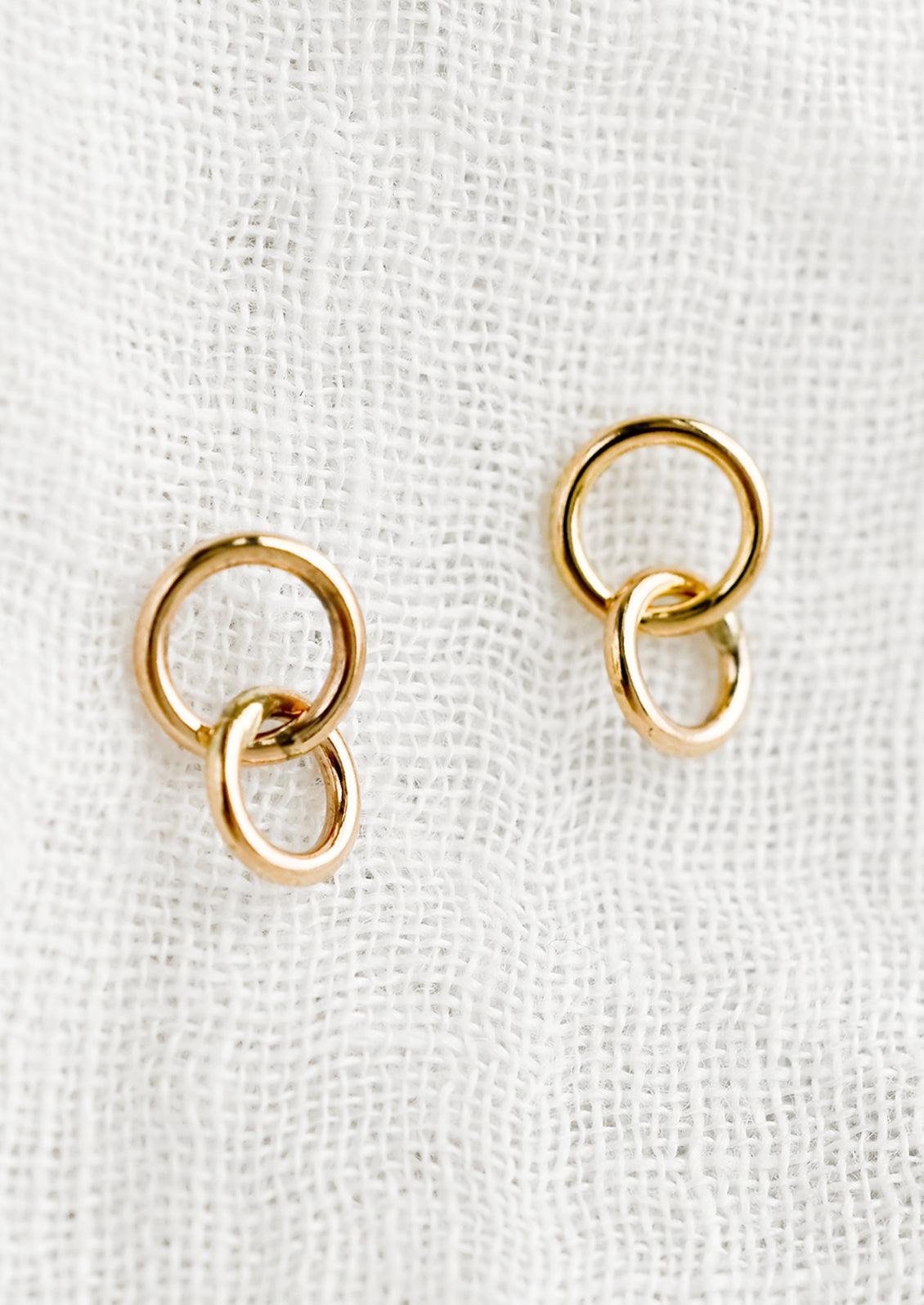 A pair of double circle gold earrings.