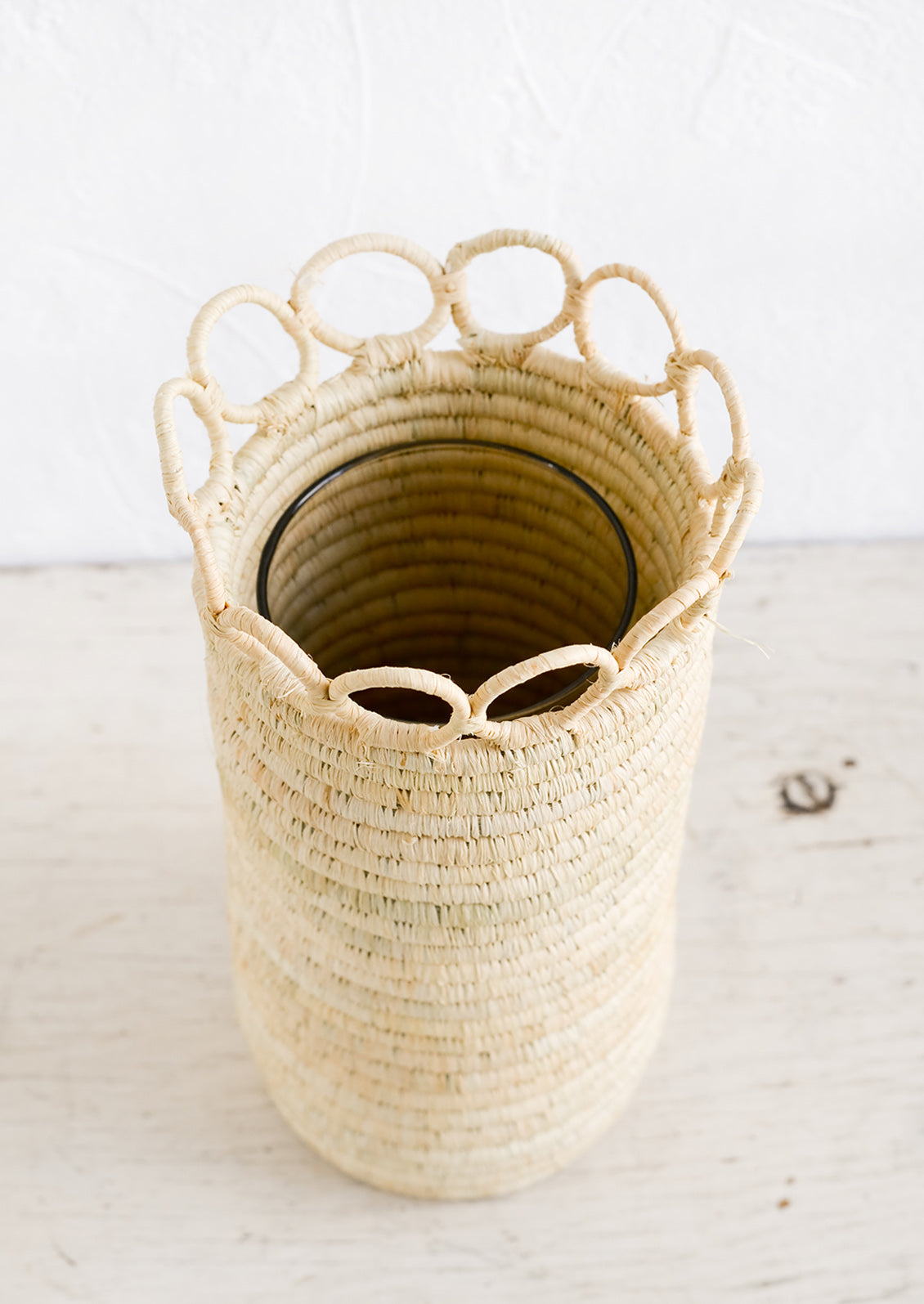A natural raffia vase with concealed glass vase insert.