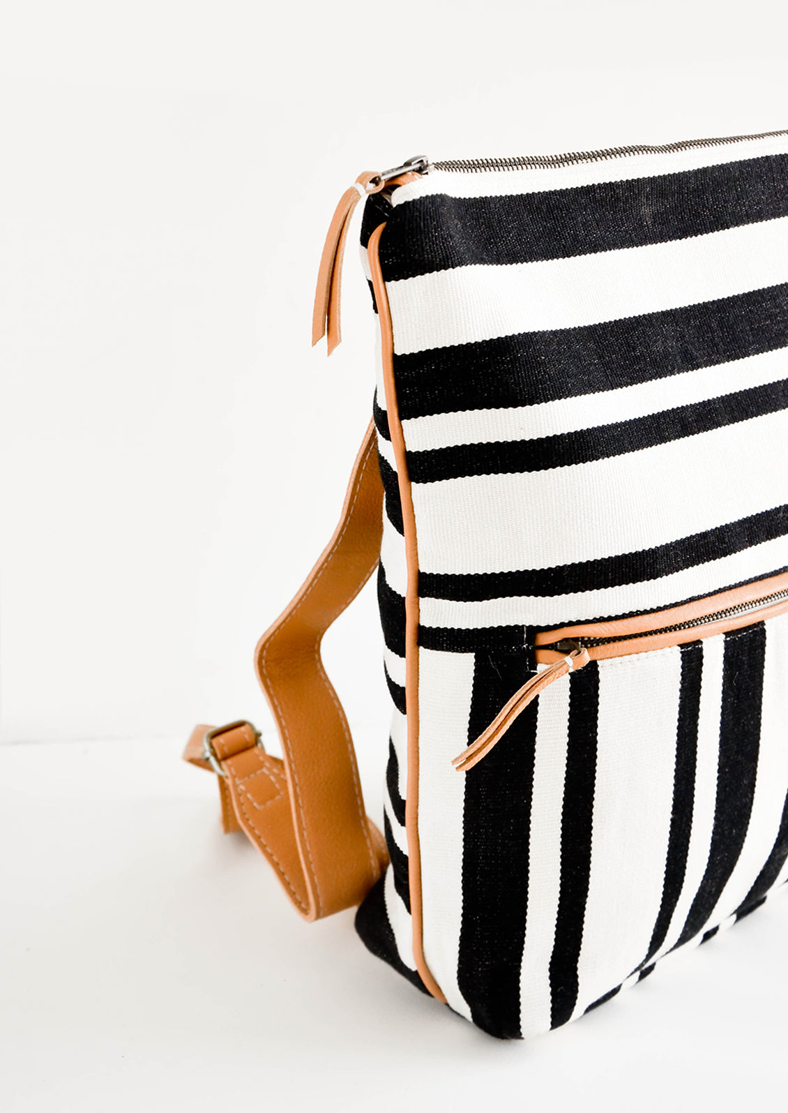 Fashion backpack in black and white striped cotton canvas with tan leather accents