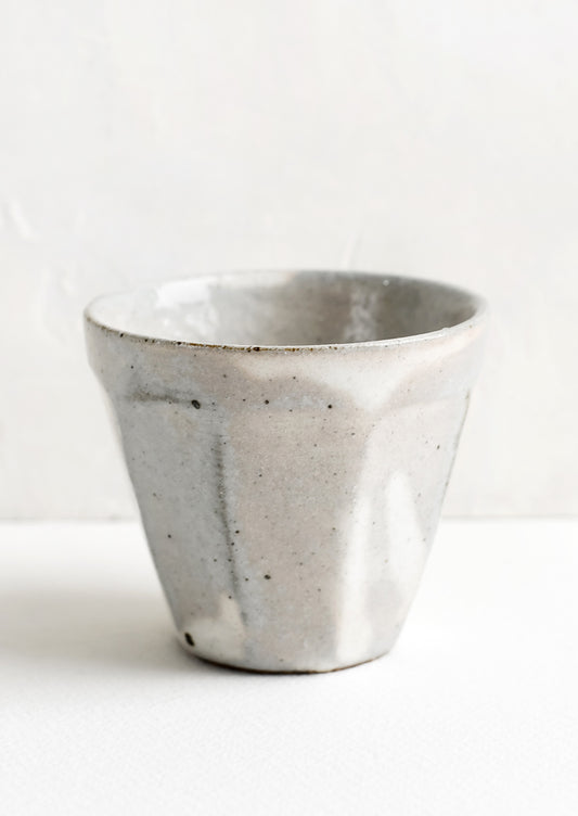 Small ceramic cups with faceted design.