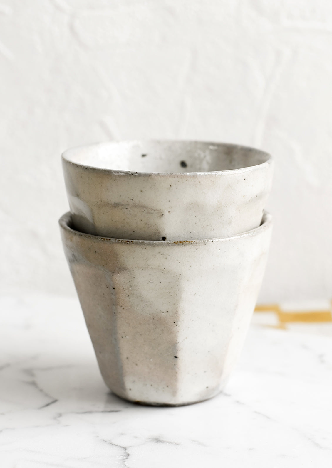 Stack of two small ceramic cups.