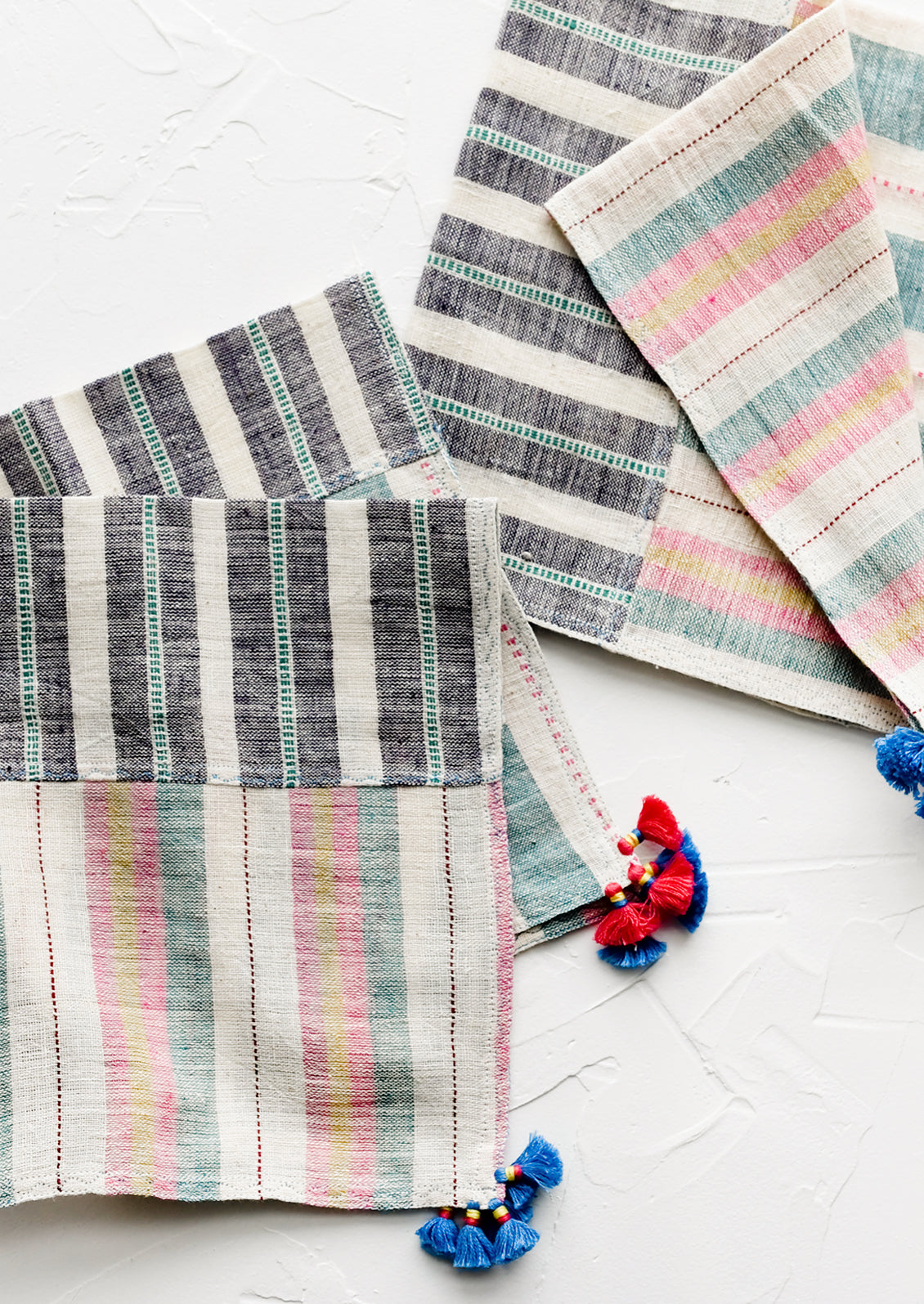 A pair of khadi cotton madras napkins with tassel detailing.