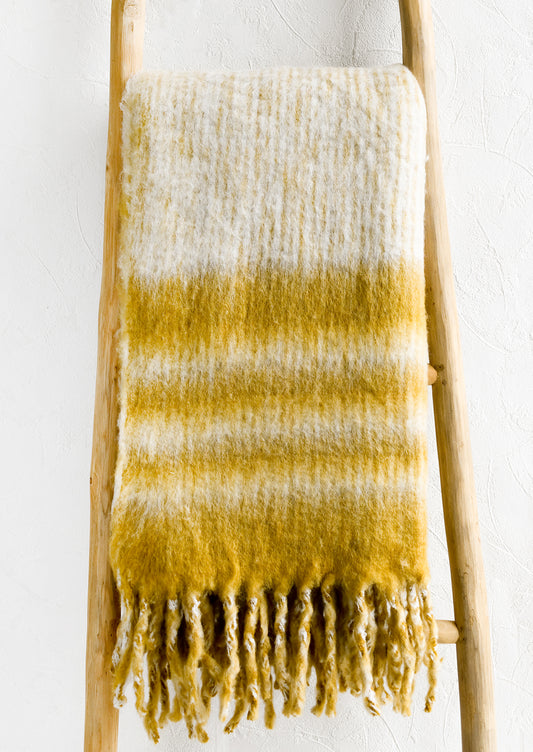 A mohair throw blanket in mustard and ivory stripe.