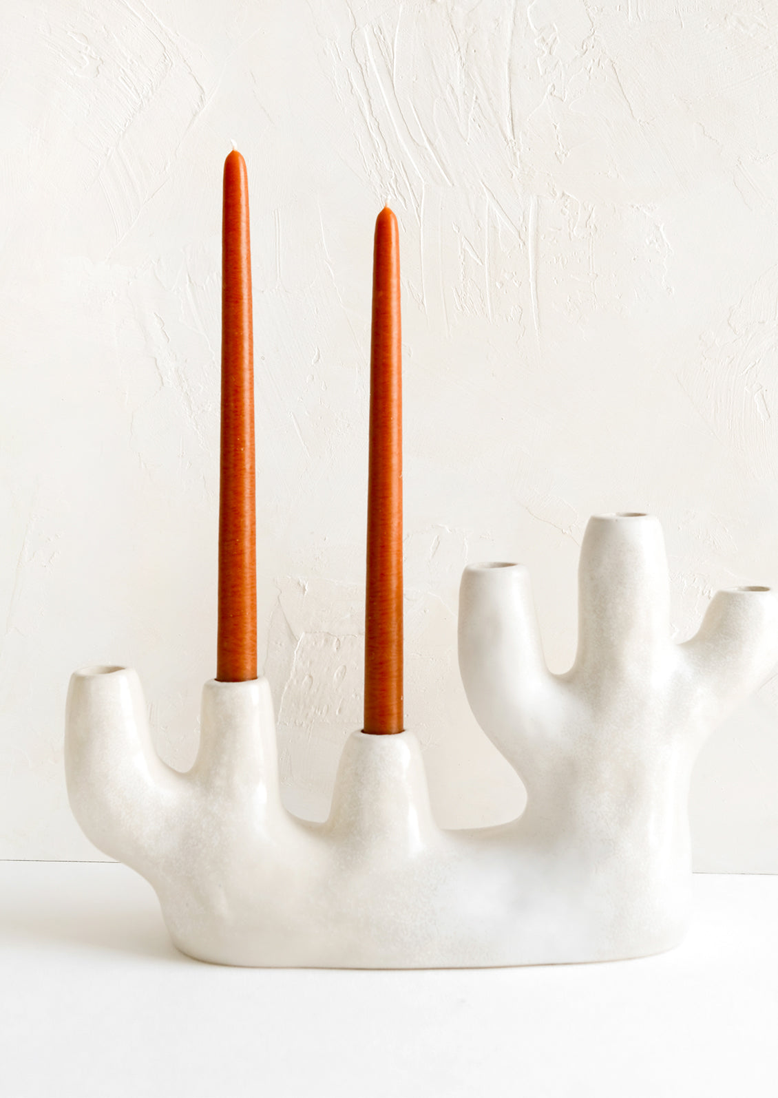 A ceramic candelabra in barnacle-like shape with six openings.