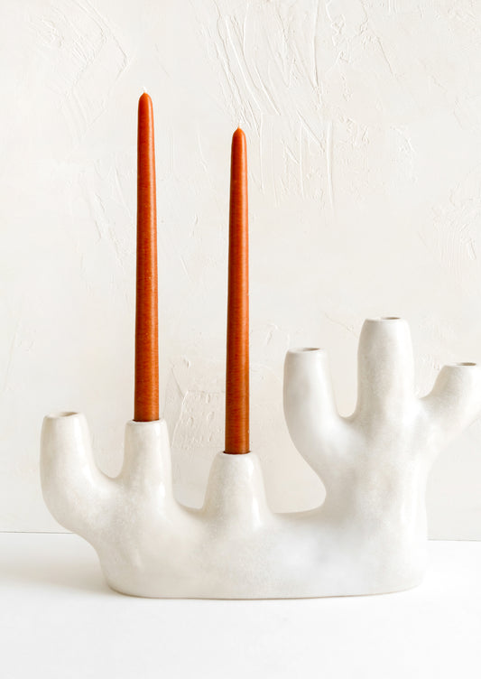 A ceramic candelabra in barnacle-like shape with six openings.