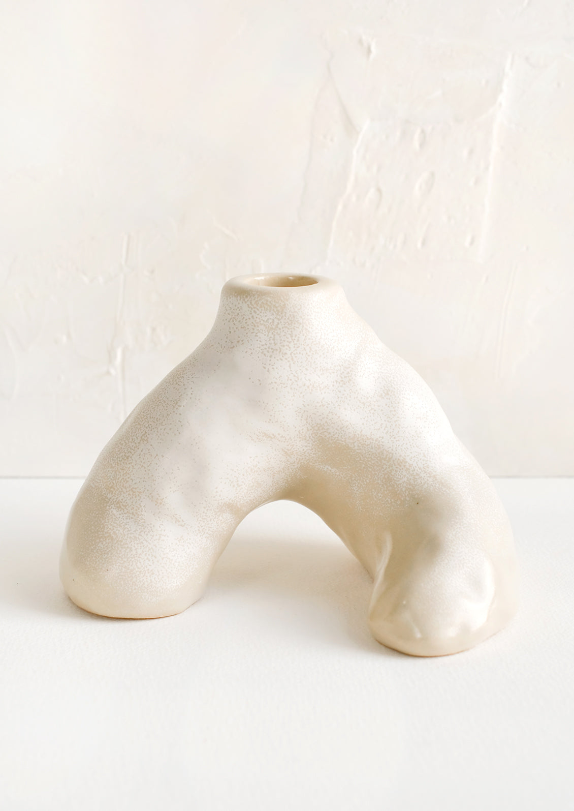 A ceramic taper holder in barnacle-like shape.