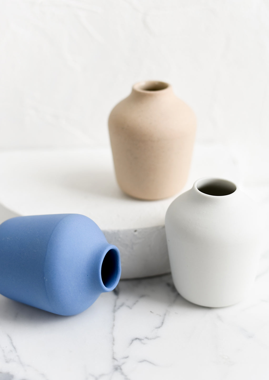 Three matte porcelain bud vases.
